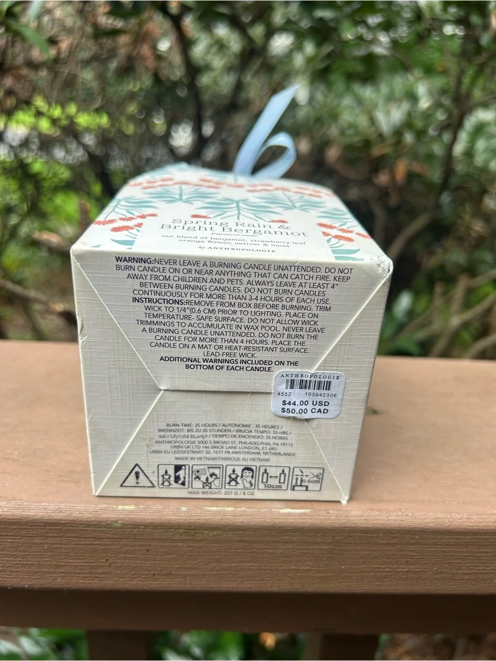 Anthropologie White Ceramic Candle with Blue Stripes and Red Floral Accents